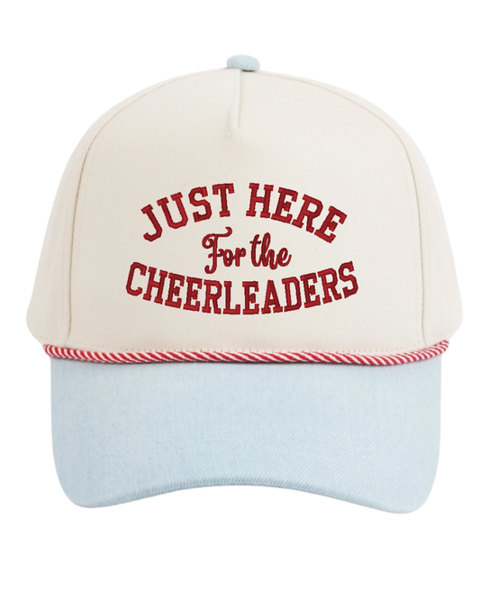 An off-white baseball cap with a light blue brim, featuring red embroidered text that reads 'JUST HERE For the CHEERLEADERS' on the front, and a red-and-white striped rope detail around the edge of the brim.