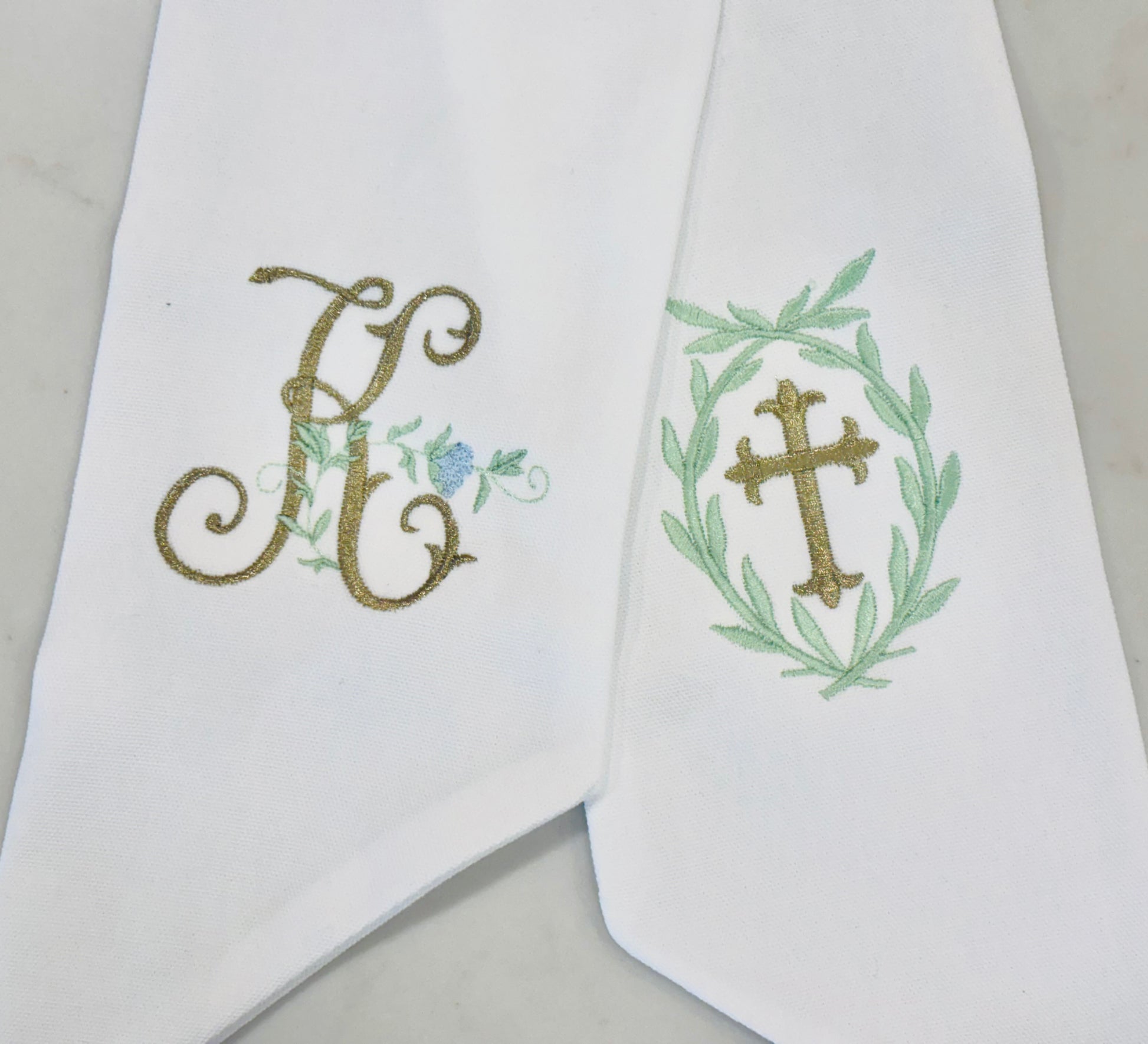 Personalized white wreath sashes with embroidered monogram and cross designs